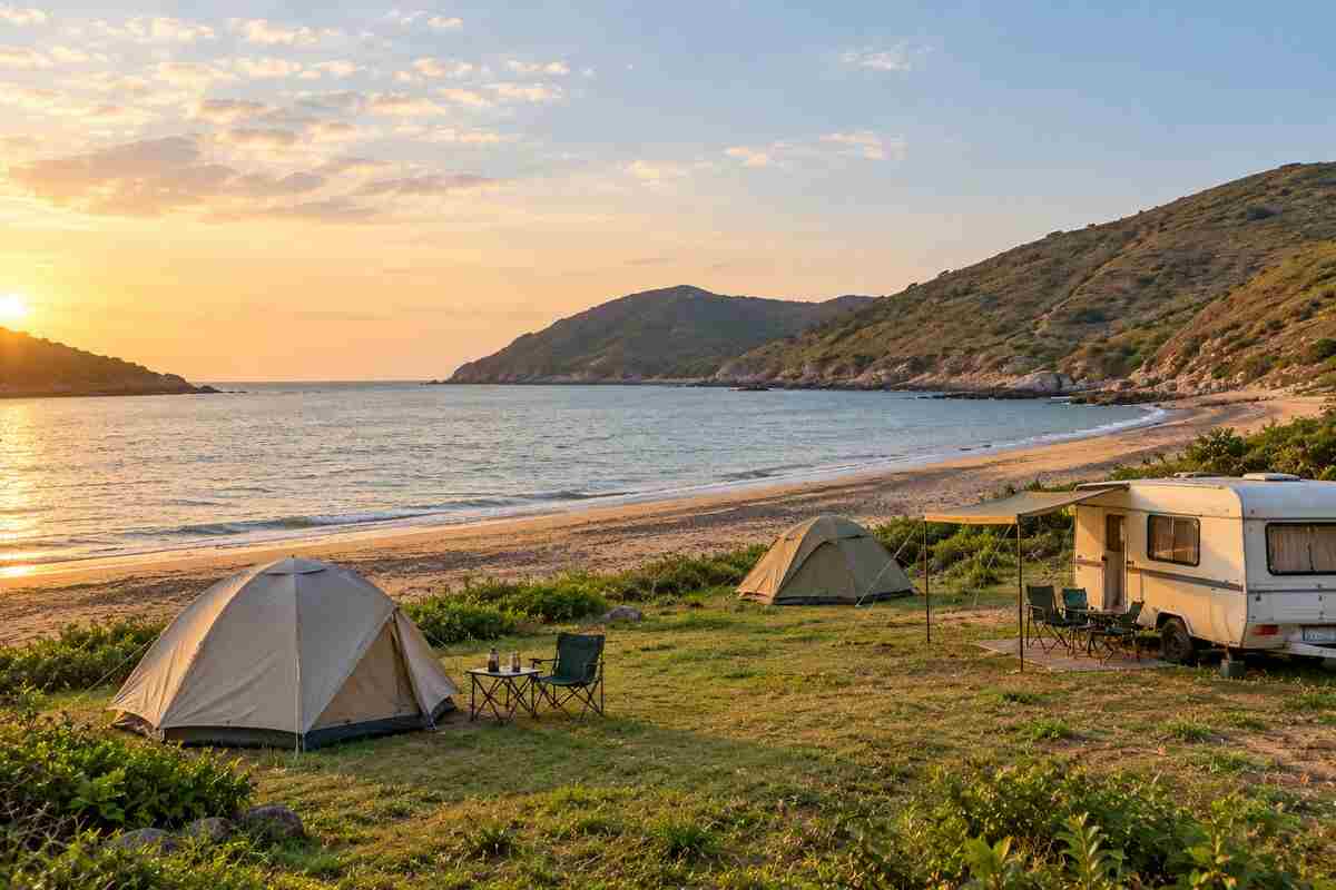 Club Pui campsite at sunset with tents and caravan on the grass near Pui O Beach, Lantau Island